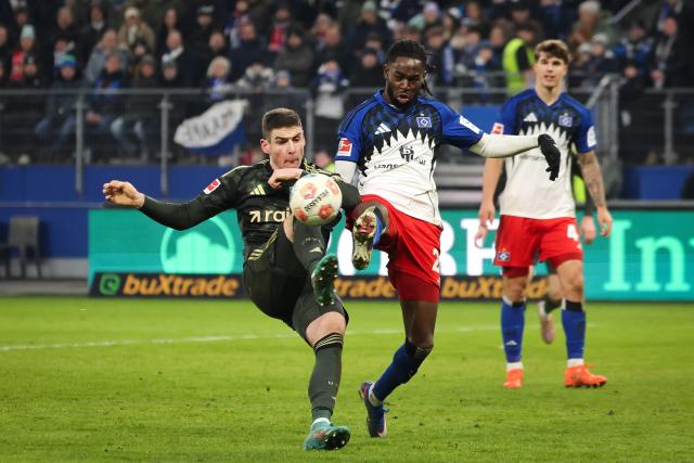 14 February 2026, Hamburg: Union Berlin's Andrej Ilic and Hamburger's Jordan Torunarigha battle for the ball during the German Bundesliga soccer match between Hamburger SV and 1.FC Union Berlin at Volksparstadion. Photo: Christian Charisius/dpa - IMPORTANT NOTE: In accordance with the regulations of the DFL German Football League and the DFB German Football Association, it is prohibited to utilize or have utilized photographs taken in the stadium and/or of the match in the form of sequential images and/or video-like photo series.