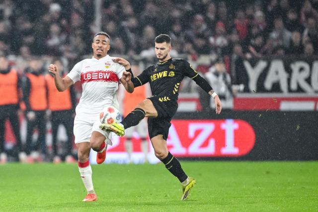 14 February 2026, Baden-Württemberg, Stuttgart: Stuttgart's Jamie Leweling and Cologne's Tom Krauss battle for the ball during the German Bundesliga soccer match between VfB Stuttgart and 1. FC Cologne at MHPArena. Photo: Harry Langer/dpa - IMPORTANT NOTE: In accordance with the regulations of the DFL German Football League and the DFB German Football Association, it is prohibited to utilize or have utilized photographs taken in the stadium and/or of the match in the form of sequential images and/or video-like photo series.