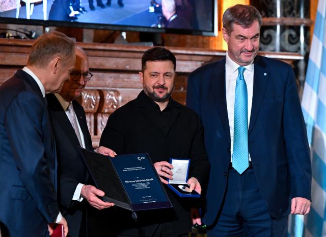 14 February 2026, Bavaria, Munich: (L-R) Donald Tusk, Prime Minister of Poland, Markus Soeder, Prime Minister of Bavaria, Volodymyr Zelensky, President of Ukraine, and Wolfgang Ischinger, Head of the Munich Security Conference, attend the Ewald von Kleist Prize award ceremony. The prize is awarded this year to the Ukrainian people. Photo: Sven Hoppe/dpa