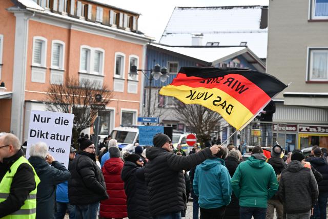 15 February 2026, Baden-Wuerttemberg, Lindenberg Im Allgäu: Thuringian Alternative for Germany (AfD) chairman Bjoern Hoecke supporters hold up posters and flags at a rally 
before his appearance. Photo: Felix Kästle/dpa
