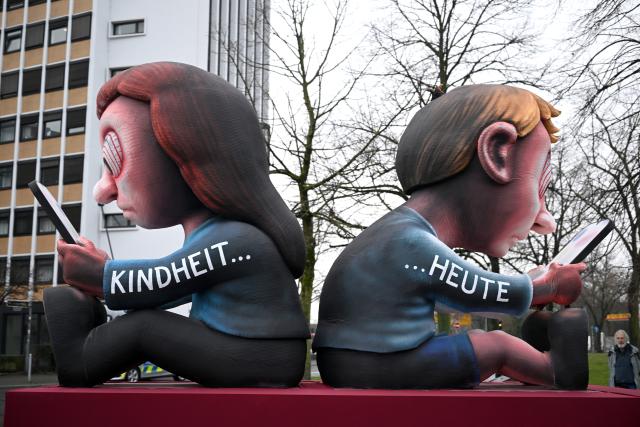 16 February 2026, North Rhine-Westphalia, Cologne: A themed float with the motif "Childhood...Today" leaves the float construction hall. Rose Monday on the Rhine is the highlight of the Rhenish carnival season with its traditional parades. Photo: Federico Gambarini/dpa