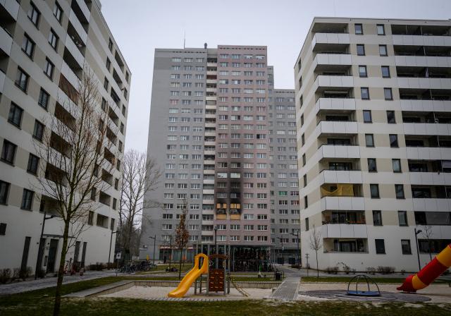 16 February 2026, Berlin: The windows and parts of the facade of a high-rise building in Dolgenseestrasse, where several people died in an apartment fire, are blackened with soot. Photo: Soeren Stache/dpa