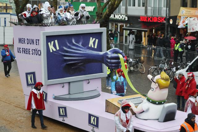16 February 2026, North Rhine-Westphalia, Cologne: A float featuring AI takes part in the Rose Monday parade in Cologne. Rose Monday on the Rhine is the highlight of the Rhenish carnival season with its traditional parades. Photo: Oliver Berg/dpa
