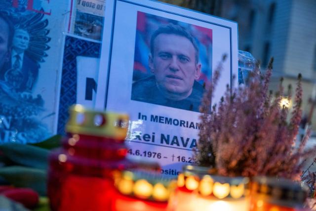 16 February 2026, Berlin: Flowers, candles, and pictures of Alexei Navalny lie in front of the Russian Embassy during a memorial service for the late Kremlin opponent. Two years after the death of Kremlin opponent Navalny, many people in Russia and other countries have commemorated the opposition leader. Photo: Christophe Gateau/dpa