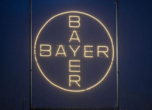 FILED - 20 November 2023, North Rhine-Westphalia, Cologne: The Bayer cross, the company's logo, lights up the Bayer factory premises in Leverkusen. Photo: Thomas Banneyer/dpa