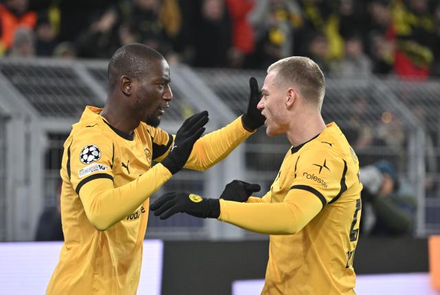17 February 2026, North Rhine-Westphalia, Dortmund: Borussia Dortmund's Serhou Guirassy (L) celebrates scoring his side's first goal with teammate Julian Ryerson during the UEFA Champions League intermediate round first leg soccer match between Borussia Dortmund and Atalanta Bergamo at the Signal Iduna Park. Photo: Bernd Thissen/dpa