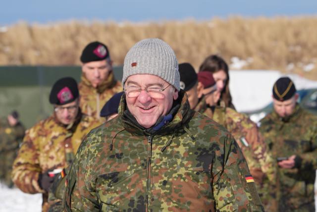 18 February 2026, Schleswig-Holstein, Putlos: Boris Pistorius (C), German Minister of Defense, walks to a helicopter after the NATO manoeuvre Steadfast Dart at the military training area on the Baltic Sea coast. Photo: Marcus Brandt/dpa