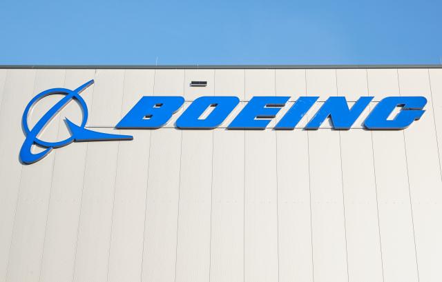 FILED - 26 October 2022, Schleswig-Holstein, Henstedt-Ulzburg: Boeing logo is pictured on a hall of the US aircraft manufacturer Boeing distribution center in Schleswig-Holstein. Photo: Georg Wendt/dpa