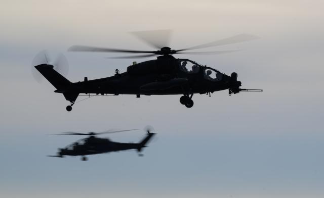 19 February 2026, Lower Saxony, Bergen: Two Agusta A129 Mangusta helicopters from the Italian military fly during a NATO exercise in Bergen. NATO's largest multinational exercise of the year began on January 15. According to the Bundeswehr, Germany is both the "hub" and host nation in the first quarter. Photo: Philipp Schulze/dpa