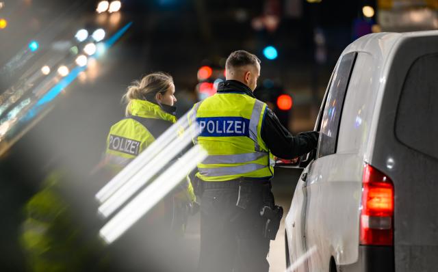 19 February 2026, Brandenburg, Frankfurt_Main: Two German police officers check the driver of a small van at the German-Polish border crossing as criticism grows over the extension of border controls in Brandenburg. The controls, in place since October 2023 to curb irregular migration, are now set to continue until September. Photo: Patrick Pleul/dpa