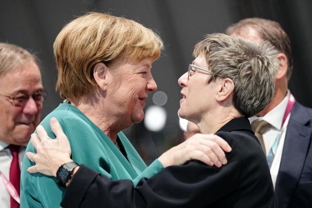 20 February 2026, Baden-Wuerttemberg, Stuttgart: Angela Merkel (2-L), former German Chancellor, hugs Annegret Kramp-Karrenbauer (R), head of the Konrad Adenauer Foundation, at the CDU federal party conference next to Armin Laschet (L), former Minister President of North Rhine-Westphalia. The CDU elects its new leadership bodies. Chancellor Merz is the only candidate for the chairmanship for the third time in a row. Photo: Kay Nietfeld/dpa pool/dpa