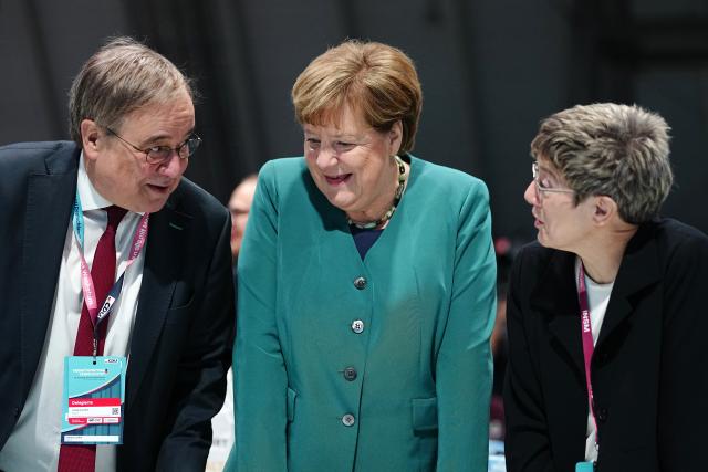 20 February 2026, Baden-Wuerttemberg, Stuttgart: Angela Merkel (C), former German Chancellor, speaks at the CDU federal party conference with Annegret Kramp-Karrenbauer (R), head of the Konrad Adenauer Foundation, and Armin Laschet (L), former Minister President of North Rhine-Westphalia. The CDU elects its new leadership bodies. Chancellor Merz is the only candidate for the chairmanship for the third time in a row. Photo: Kay Nietfeld/dpa pool/dpa