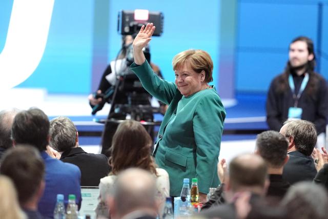 20 February 2026, Baden-Württemberg, Stuttgart: Angela Merkel Former German Chancellor, waves into the hall at the CDU federal party conference. The CDU elects its new leadership bodies. Chancellor Merz is the only candidate for the chairmanship for the third time in a row. Photo: Kay Nietfeld/dpa