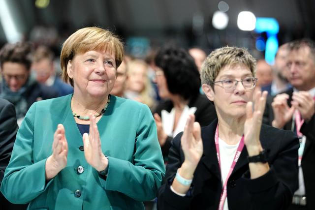 20 February 2026, Baden-Wuerttemberg, Stuttgart: Former German Chancellor Angela Merkel (L) and head of the Konrad Adenauer Foundation Annegret Kramp-Karrenbauer (CDU) applaud after Chancellor Friedrich Merz's speech at the Christian Democratic Union of Germany (CDU) federal party conference. Photo: Kay Nietfeld/dpa