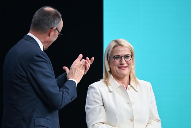 20 February 2026, Baden-Wuerttemberg, Stuttgart: German Chancellor and Christian Democratic Union of Germany (CDU) party leader Friedrich Merz applauds CDU deputy Secretary General Christina Stumpp after her discharge speech at the CDU federal party conference. Photo: Katharina Kausche/dpa