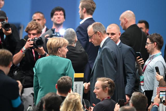 20 February 2026, Baden-Wuerttemberg, Stuttgart: German Chancellor and Christian Democratic Union of Germany (CDU) party leader Friedrich Merz and former chancellor Angela Merkel leave after the CDU federal party conference. The CDU elects its new leadership. Photo: Katharina Kausche/dpa