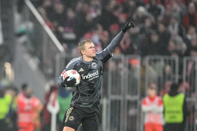 21 February 2026, Bavaria, Munich: Eintracht Frankfurt's Jonathan Burkardt celebrates scoring his side's first goal during the German Bundesliga soccer match between Bayern Munich and Eintracht Frankfurt at Allianz Arena. Photo: Harry Langer/dpa - WICHTIGER HINWEIS: Gemäß den Vorgaben der DFL Deutsche Fußball Liga bzw. des DFB Deutscher Fußball-Bund ist es untersagt, in dem Stadion und/oder vom Spiel angefertigte Fotoaufnahmen in Form von Sequenzbildern und/oder videoähnlichen Fotostrecken zu verwerten bzw. verwerten zu lassen.