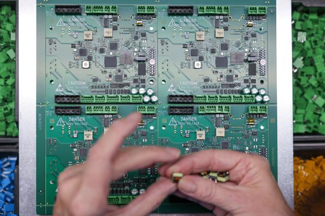 FILED - 17 November 2023, Saxony, Schoeneck: An employee assembles a circuit board for digital radios in the production facilities of TechniSat Vogtland GmbH. Photo: Jan Woitas/dpa