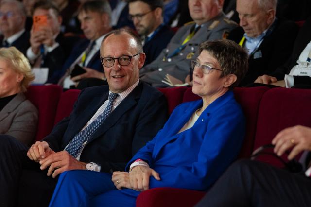 23 February 2026, Berlin: German Chancellor Friedrich Merz sits next to Annegret Kramp-Karrenbauer (CDU), head of the Konrad Adenauer Foundation at the opening of "Cafe Kyiv" (Kiev), an event organized by the Konrad Adenauer Foundation and attended by political, academic and cultural figures. Photo: Markus Lenhardt/dpa