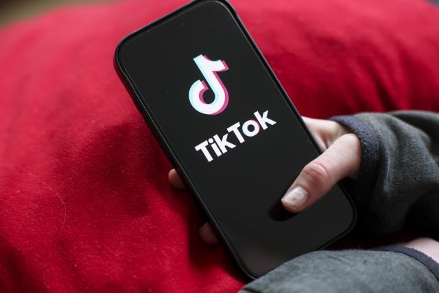 FILED - 17 February 2026, Saxony, Leipzig: A girl holds an iPhone 16 with the logo of the TikTok app on it. German Culture Minister Wolfram Weimer on Monday proposed placing Chinese-owned social media platform TikTok in the hands of European companies, citing concerns over data sovereignty and data flows. Photo: Jan Woitas/dpa