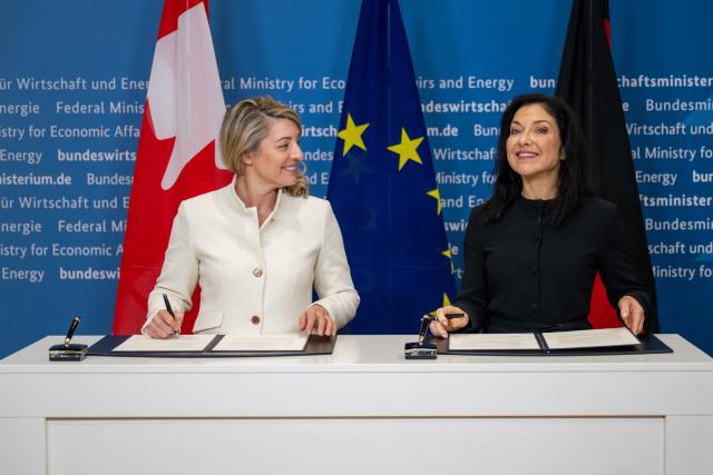 23 February 2026, Berlin: Melanie Joly (L), Canadian Minister of Industry, and Katherina Reiche, German Minister for Economic Affairs and Energy, sign a memorandum of understanding on cooperation in the automotive and mobility sectors. Photo: Christophe Gateau/dpa