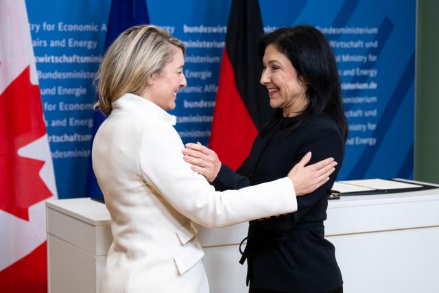 23 February 2026, Berlin: Melanie Joly (L), Canadian Minister of Industry, and Katherina Reiche, German Minister for Economic Affairs and Energy, pose together after signing a memorandum of understanding on cooperation in the automotive and mobility sectors. Photo: Christophe Gateau/dpa