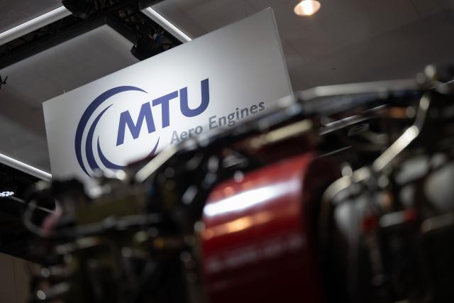 FILED - 06 June 2024, Brandenburg, Schoenefeld: The logo of the engine manufacturer "MTU Aero Engines" hangs on the grounds of Berlin Brandenburg Airport (BER) during the International Aerospace Exhibition (ILA). Photo: Sebastian Gollnow/dpa