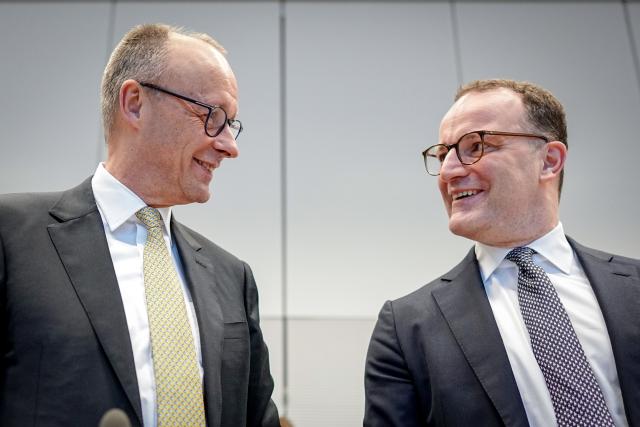 24 February 2026, Berlin: German Chancellor Friedrich Merz (L) and Jens Spahn, chairman of the Union faction in the Bundestag, take part in a CDU/CSU parliamentary group meeting. Photo: Kay Nietfeld/dpa