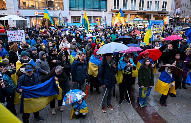 24 February 2026, Bavaria, Munich: People take part in a rally on Marienplatz to mark the fourth anniversary of Russia's attack on Ukraine. Photo: Sven Hoppe/dpa