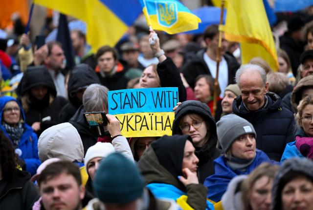 24 February 2026, Bavaria, Munich: People take part in a rally on Marienplatz to mark the fourth anniversary of Russia's attack on Ukraine. Photo: Sven Hoppe/dpa