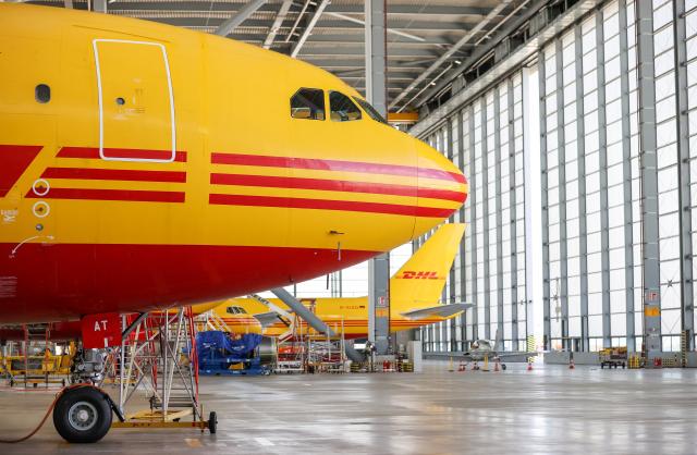 FILED - 29 July 2020, Saxony, Schkeuditz: DHL cargo aircraft are parked inside a hangar at Leipzig/Halle Airport. Several major airlines lost their appeals against European Union antitrust fines totalling more than 770 million euros ($910 million), according to a ruling issued by the EU's highest court on Thursday. Photo: Jan Woitas/dpa-Zentralbild/dpa