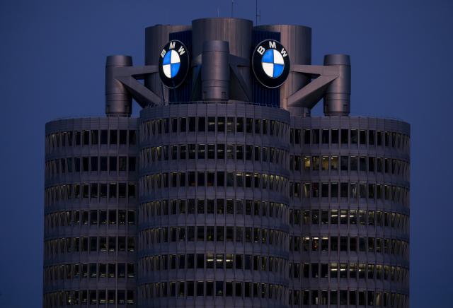 FILED - 19 May 2025, Bavaria, Munich: BMW headquarters with BMW logo in the evening. BMW, the luxury German carmaker, is testing humanoid robots at its production facility in the east German city of Leipzig, the company announced on Friday. Photo: Peter Kneffel/dpa