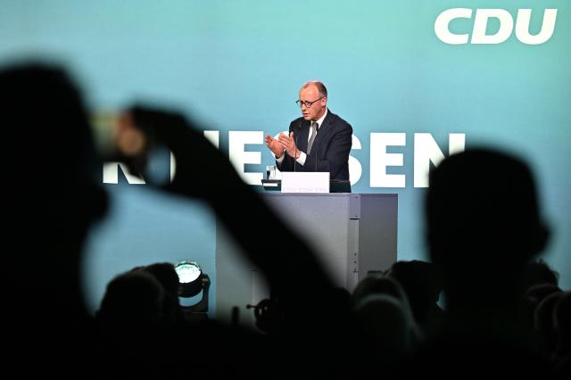 27 February 2026, Hesse, Volkmarsen: Germany's Chancellor Friedrich Merz speaks at an election campaign event in the Nordhessenhalle, marking the start of the CDU federal chairman's final push in the local election campaign ahead of the March 15, 2026, vote in Hesse. Photo: Swen Pförtner/dpa