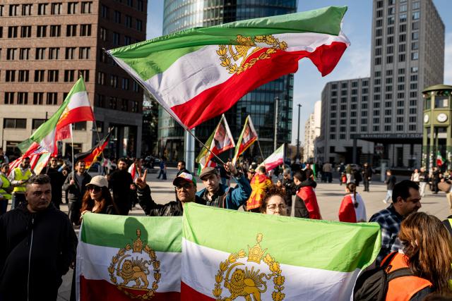 28 February 2026, Berlin: People take part in a demonstration organized by the National Council of Resistance of Iran at Potsdamer Platz. Photo: Fabian Sommer/dpa