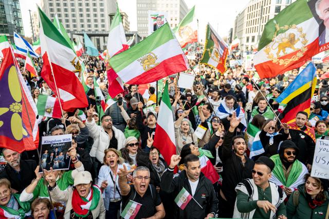 28 February 2026, Berlin: People take part in a demonstration organized by the National Council of Resistance of Iran at Potsdamer Platz. Photo: Fabian Sommer/dpa