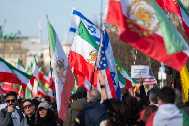 28 February 2026, Berlin: People take part in a demonstration organized by the National Council of Resistance of Iran in Berlin. Photo: Christophe Gateau/dpa