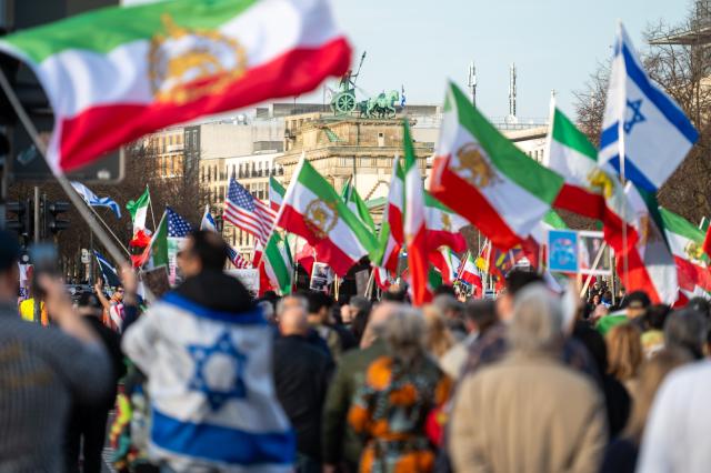 28 February 2026, Berlin: People take part in a demonstration organized by the National Council of Resistance of Iran in Berlin. Photo: Christophe Gateau/dpa