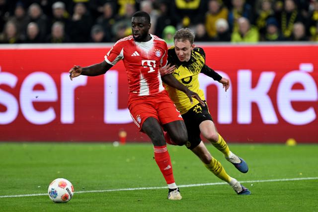28 February 2026, North Rhine-Westphalia, Dortmund: Bayern Munich's Dayot Upamecano (L) and Borussia Dortmund's Maximilian Beier battle for the ball during the German Bundesliga soccer match between Borussia Dortmund and FC Bayern Munich at Signal Iduna Park. Photo: Federico Gambarini/dpa - IMPORTANT NOTICE: DFL and DFB regulations prohibit any use of photographs as image sequences and/or quasi-video.