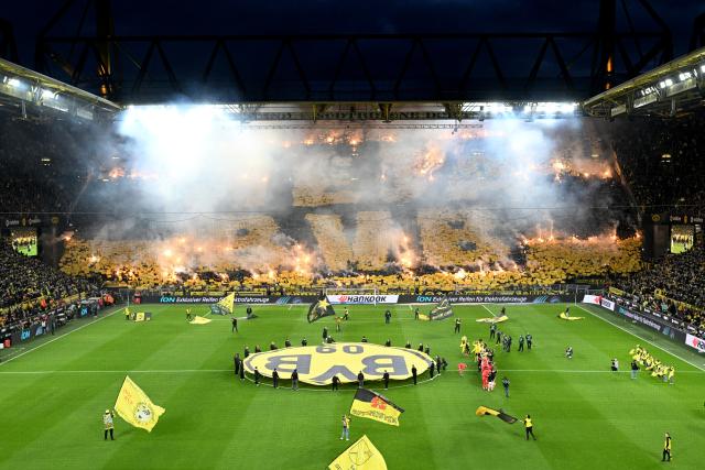 28 February 2026, North Rhine-Westphalia, Dortmund: Dortmund fans in the south stand display a choreographed display with the words "Heja BVB" ahead of the German Bundesliga soccer match between Borussia Dortmund and FC Bayern Munich at Signal Iduna Park. Photo: Federico Gambarini/dpa - IMPORTANT NOTICE: DFL and DFB regulations prohibit any use of photographs as image sequences and/or quasi-video.