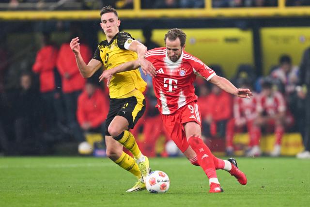 28 February 2026, North Rhine-Westphalia, Dortmund: Borussia Dortmund's Nico Schlotterbeck (L) and Bayern Munich's Harry Kane battle for the ball during the German Bundesliga soccer match between Borussia Dortmund and FC Bayern Munich at Signal Iduna Park. Photo: David Inderlied/dpa - IMPORTANT NOTICE: DFL and DFB regulations prohibit any use of photographs as image sequences and/or quasi-video.