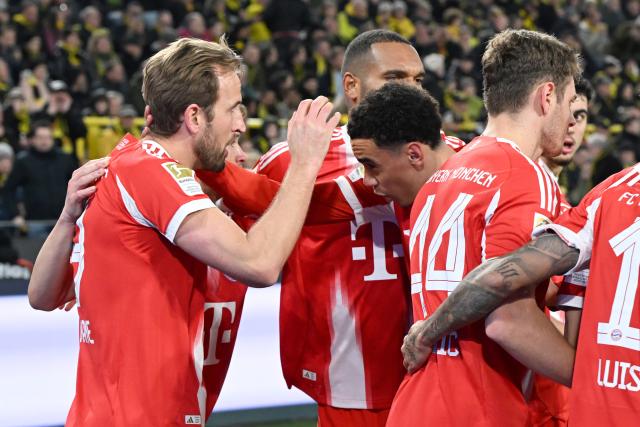 28 February 2026, North Rhine-Westphalia, Dortmund: Bayern Munich's Harry Kane (L) celebrates his side's second goal of the game with Bayern Munich's Jamal Musiala during the German Bundesliga soccer match between Borussia Dortmund and FC Bayern Munich at Signal Iduna Park. Photo: Federico Gambarini/dpa - IMPORTANT NOTICE: DFL and DFB regulations prohibit any use of photographs as image sequences and/or quasi-video.