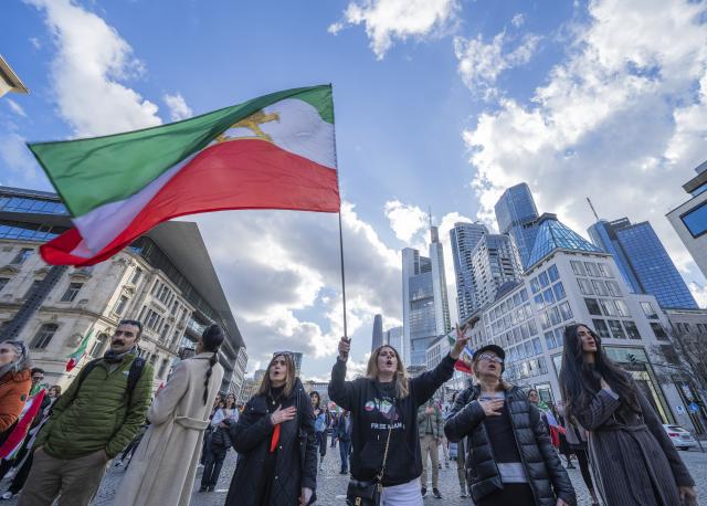 01 March 2026, Hesse, Frankfurt_Main: People celebrate the death of Iran's supreme leader, Ayatollah Khamenei during a protest at Goetheplatz against the Iranian mullah regime. Photo: Andreas Arnold/dpa