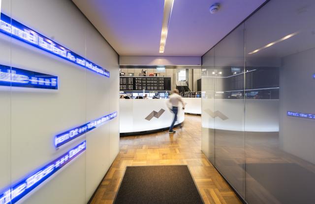 02 March 2026, Hesse, Frankfurt/Main: A man walks through the trading room at the stock exchange. The attacks in the Middle East are causing shifts on the financial market. Photo: Andreas Arnold/dpa