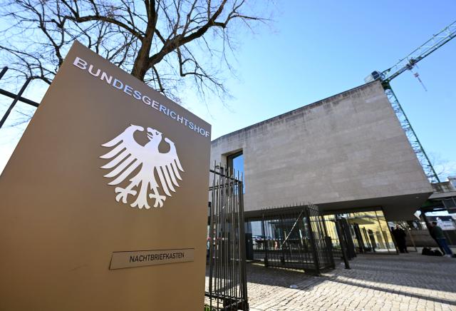 02 March 2026, Baden-Wuerttemberg, Karlsruhe: A sign with the federal eagle and the words "Bundesgerichtshof" (Federal Court of Justice), photographed in front of the Federal Court of Justice (BGH). Germany's Federal Court of Justice (BGH) on Monday heard two climate lawsuits against carmakers BMW and Mercedes-Benz. Photo: Uli Deck/dpa