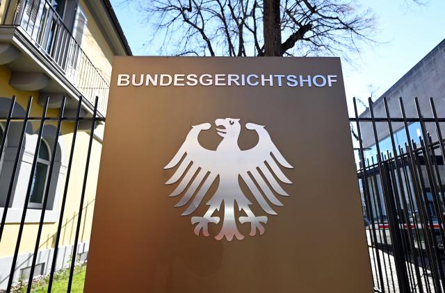 02 March 2026, Baden-Wuerttemberg, Karlsruhe: A sign with the federal eagle and the words "Bundesgerichtshof" (Federal Court of Justice), photographed in front of the Federal Court of Justice (BGH). Germany's Federal Court of Justice (BGH) on Monday heard two climate lawsuits against carmakers BMW and Mercedes-Benz. Photo: Uli Deck/dpa