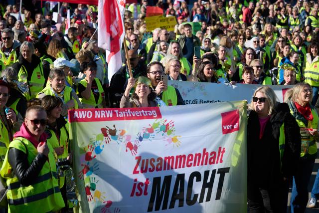 03 March 2026, North Rhine-Westphalia, Dortmund: Employees of the Workers' Welfare Association (AWO) demonstrate holding a banner reading "Solidarity is power". Following several regional warning strikes at AWO facilities, the Verdi union calls for a nationwide AWO strike day in North Rhine-Westphalia. Photo: Bernd Thissen/dpa