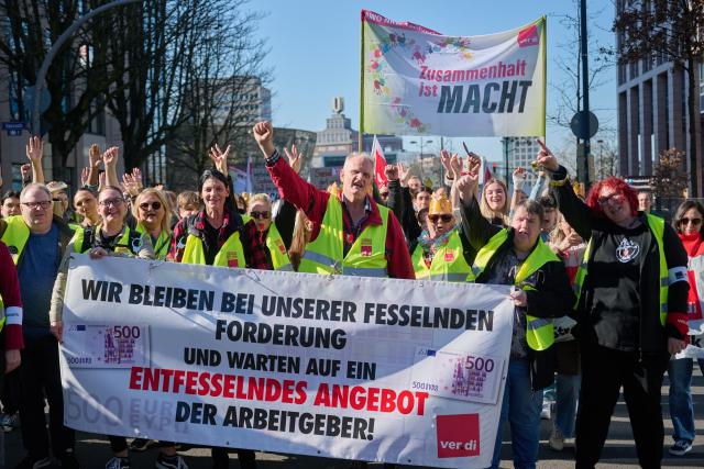 03 March 2026, North Rhine-Westphalia, Dortmund: Employees of the Workers' Welfare Association (AWO) demonstrate holding a banner reading "Solidarity is power". Following several regional warning strikes at AWO facilities, the Verdi union calls for a nationwide AWO strike day in North Rhine-Westphalia. Photo: Bernd Thissen/dpa