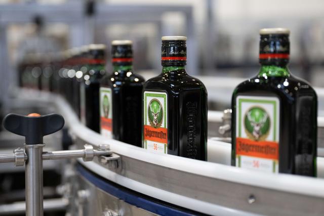 FILED - 28 November 2023, Kamenz: Glass bottles stand in the bottling plant of herbal liqueur manufacturer Jägermeister. Photo: Sebastian Kahnert/dpa