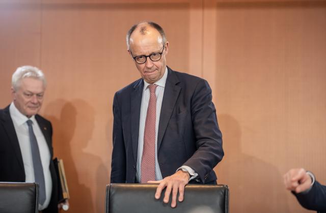 04 March 2026, Berlin: Germany's Chancellor Friedrich Merz (C) takes his seat next to Alois Rainer (L), Germany's Minister for Food, Agriculture, and Home Affairs, at the start of the German Cabinet meeting in the Federal Chancellery. Photo: Michael Kappeler/dpa