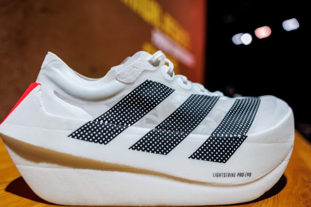04 March 2026, Bavaria, Herzogenaurach: The logo and lettering of sporting goods manufacturer Adidas AG are prominently displayed on the "Adidas Adizero Prime X Evo Unisex" shoe showcased at the company's annual results press conference. Photo: Daniel Karmann/dpa